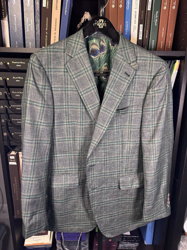 Green and grey windowpane sport coat with a peacock-feather lining visible at the collar