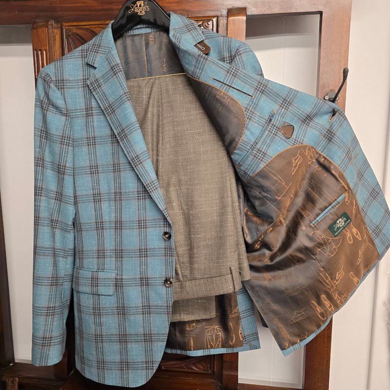 Teal plaid sport coat with taupe trousers and a brown lining printed with shoe sketches